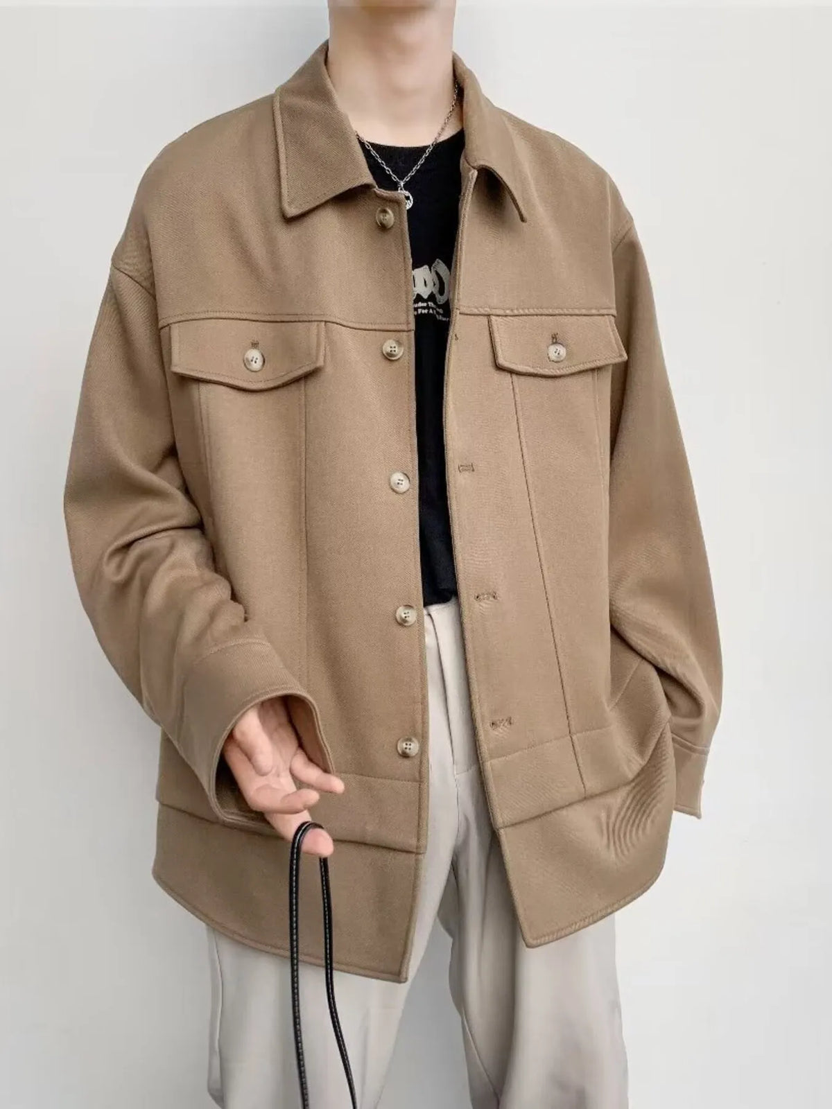 Oversized khaki button-down jacket with chest pockets and a relaxed fit.