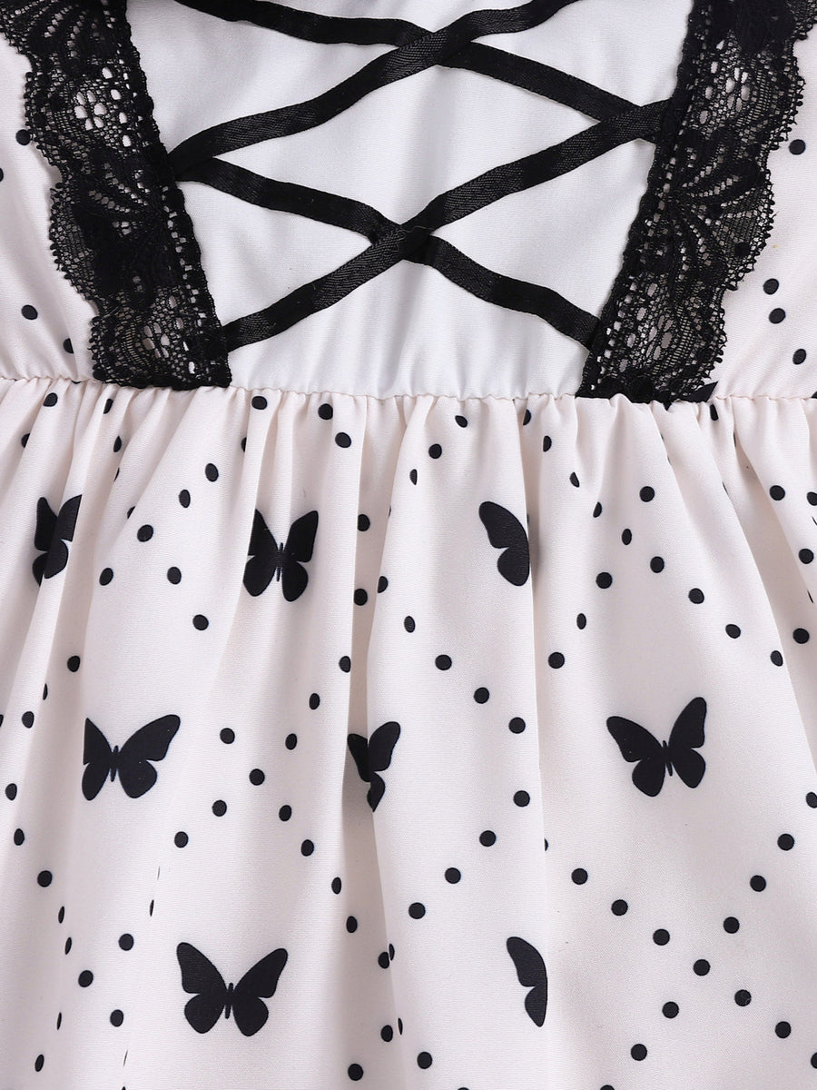 Baby dress with butterfly print, polka dots, black lace trim, and crisscross ribbon detail.