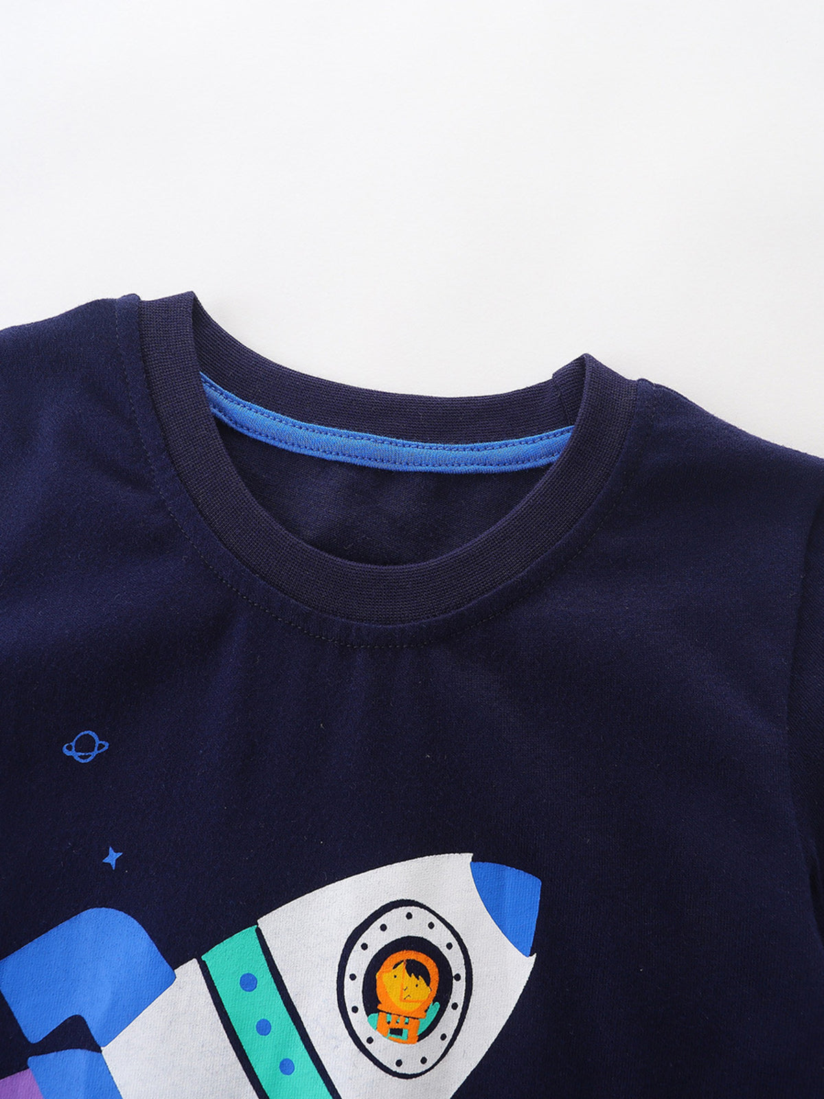 Navy cotton toddler t-shirt with a rocket ship and astronaut graphic.
