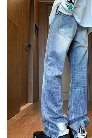 Men's wide-leg jeans with ombre wash and distressed details.