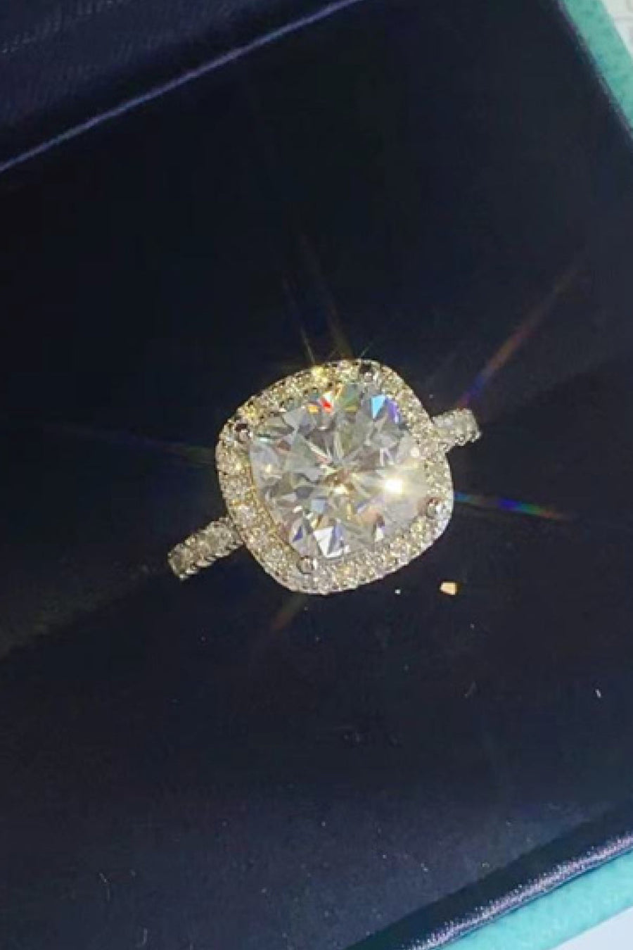 White cushion-cut halo engagement ring with diamond band