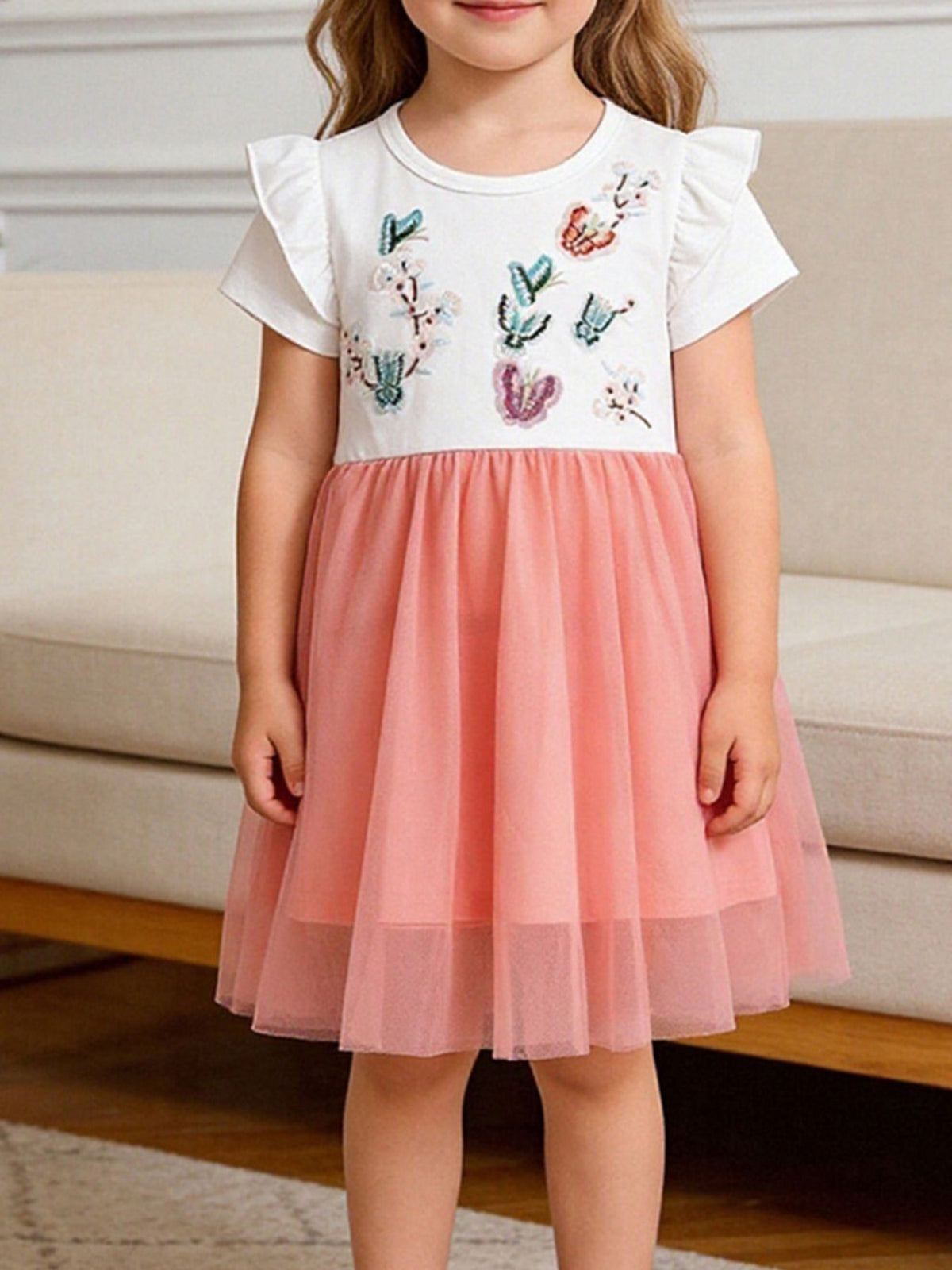 Toddler white cotton dress with embroidered butterflies and a pink tulle skirt.