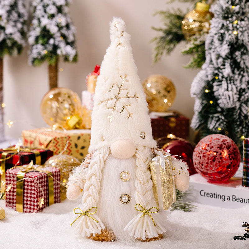 Illuminated festive gnome with white fluffy hat and braids, holding a gift.