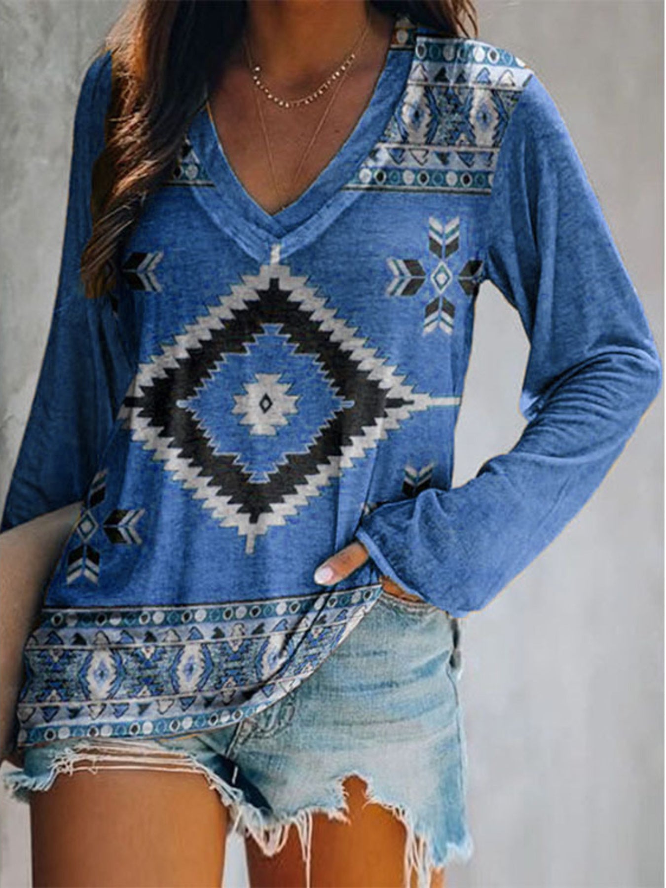 Blue long sleeve v-neck t-shirt with geometric Aztec print and tribal border