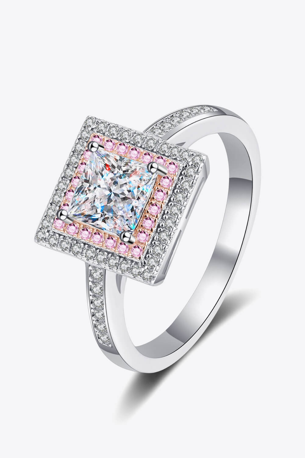 Princess cut halo ring with pink accents and clear stones on silver band