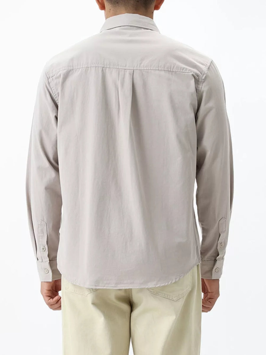 Men's light gray cotton button-down shirt with long sleeves and button cuffs.