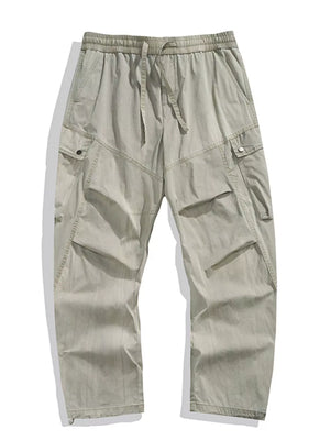 Loose fit khaki cargo pants with drawstring waist and multiple pockets.