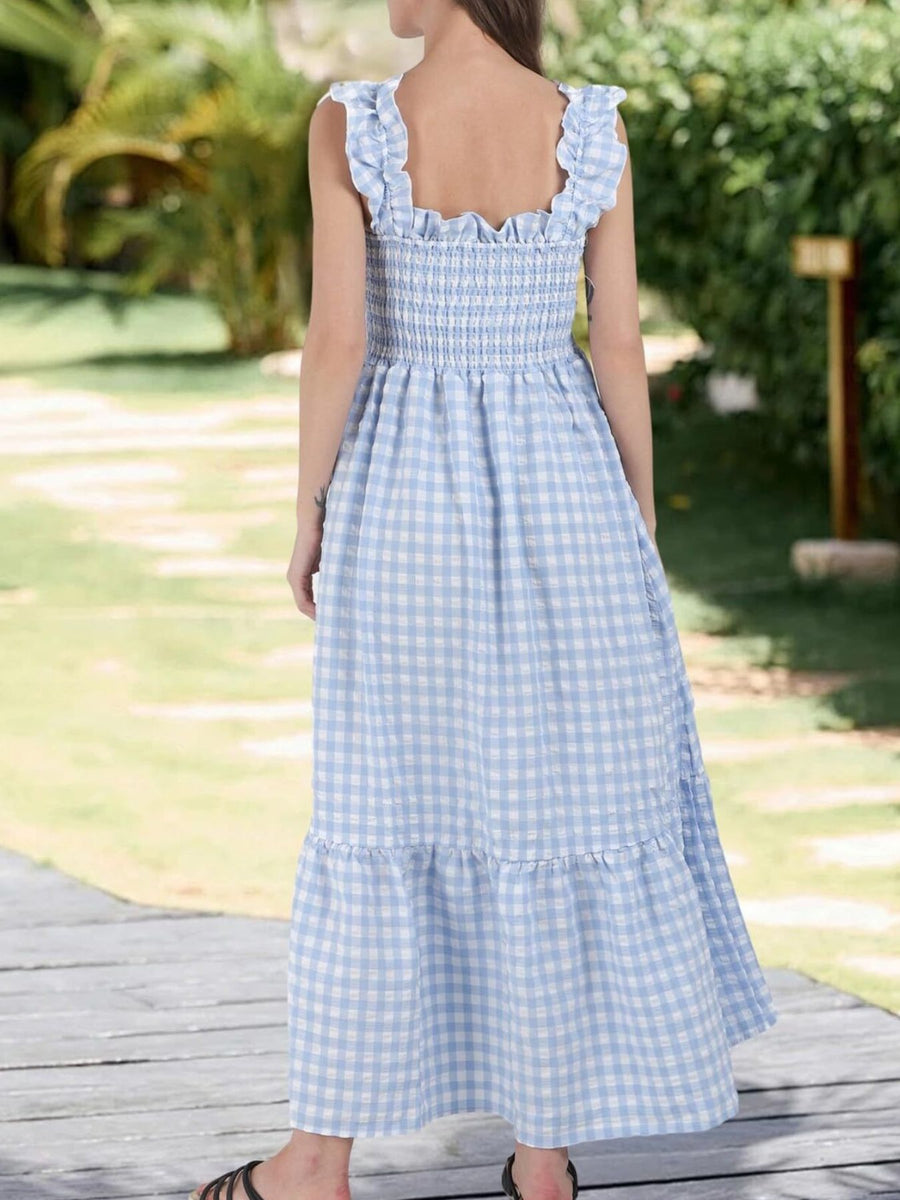Blue gingham midi dress with smocked bodice, ruffled straps, and tiered skirt.