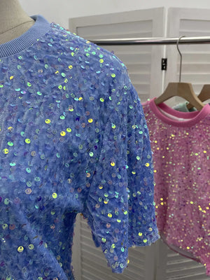 Blue crew neck t-shirt with iridescent sequins and textured fabric.