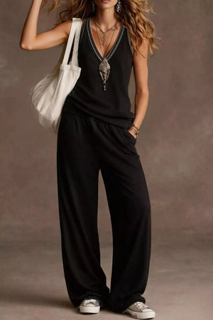 Black V-neck tank with embroidered trim and wide-leg pants with elastic waist