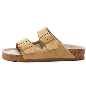 Camel suede slide sandals with adjustable buckle straps and cork sole.