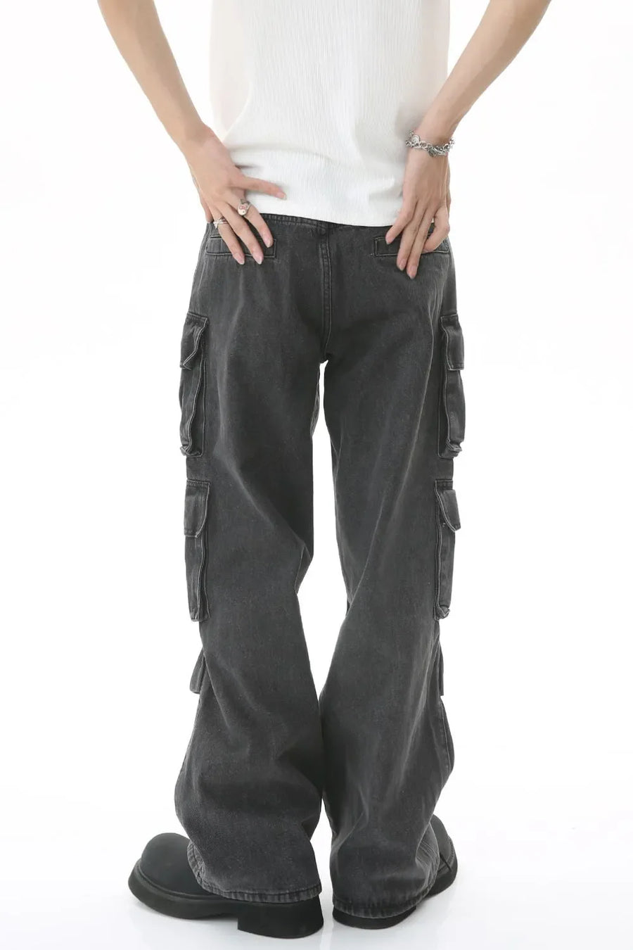 Baggy dark wash denim cargo pants with multiple pockets and pleated details.