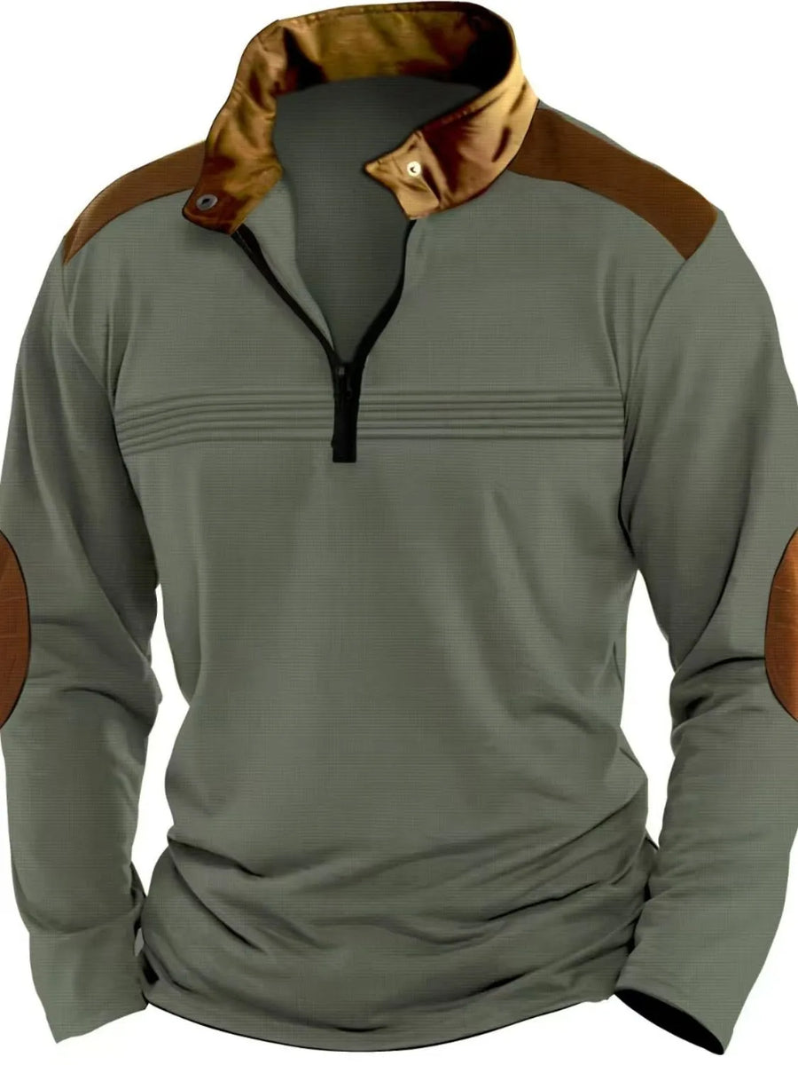 Sage quarter-zip pullover with brown contrast panels and elbow patches.