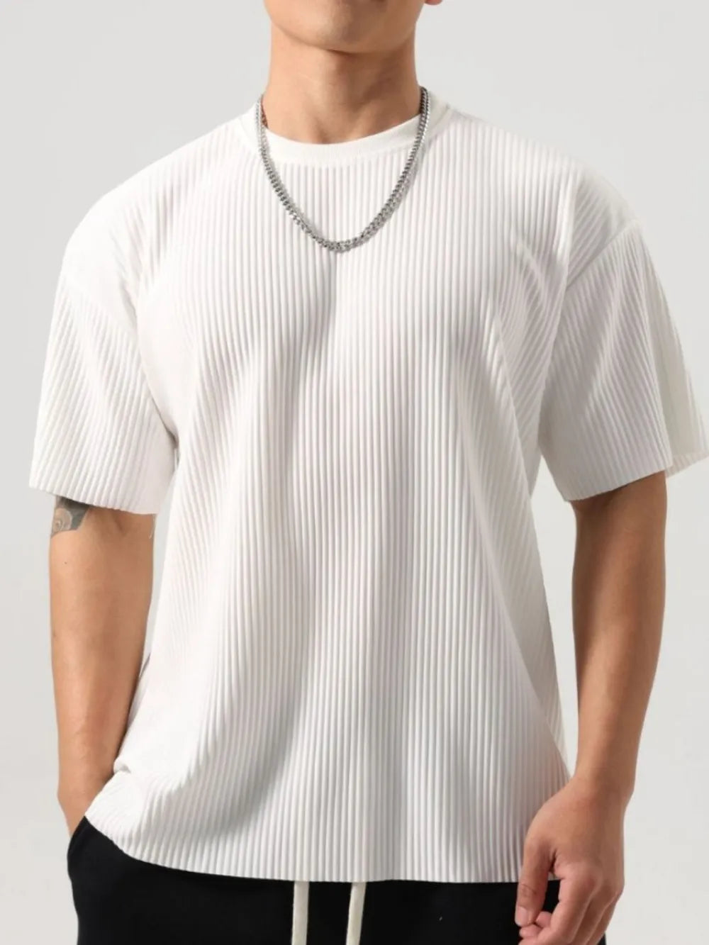 White pleated oversized t-shirt with sculpted texture and crew neck.