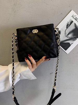 Black quilted pu leather crossbody bag with gold chain strap and clasp detail.
