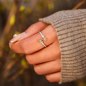 Rosebud bypass ring in silver with pavé detail and two rose charms.