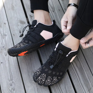 Black perforated mesh water-ready lace-up athletic shoes with pink accents and white patterned toe.