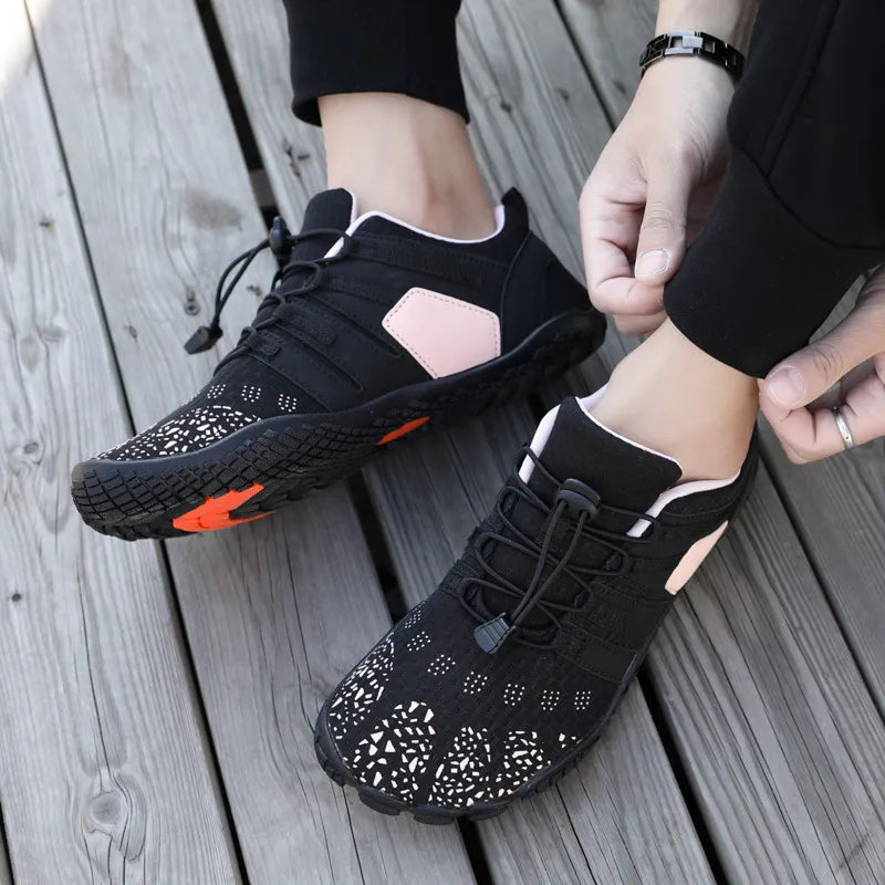 Black perforated mesh water-ready lace-up athletic shoes with pink accents and white patterned toe.