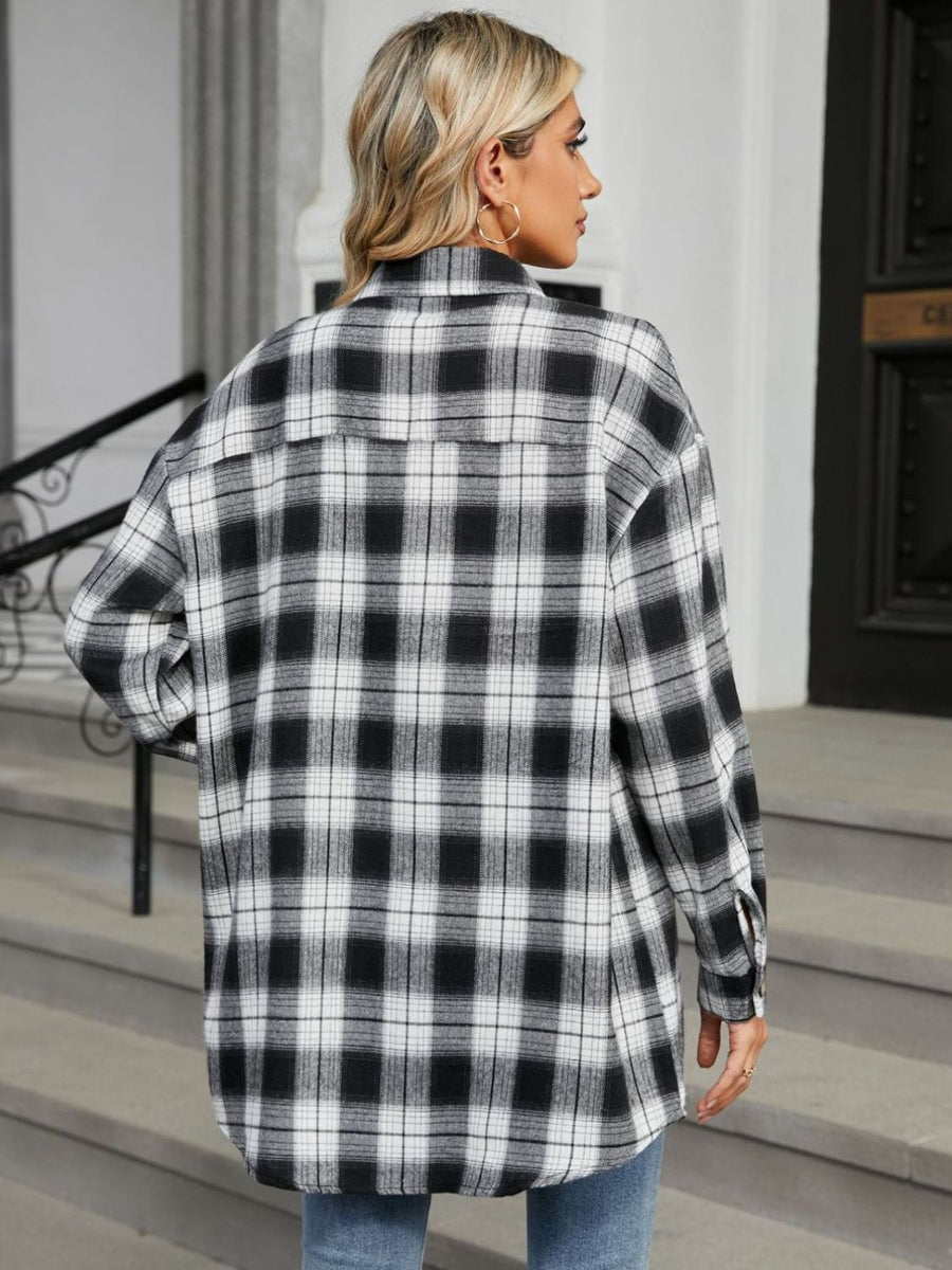 Oversized black and white plaid shacket with buttoned cuffs.