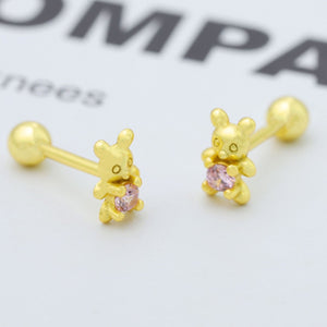 Gold bear stud earrings with pink zircon stones.