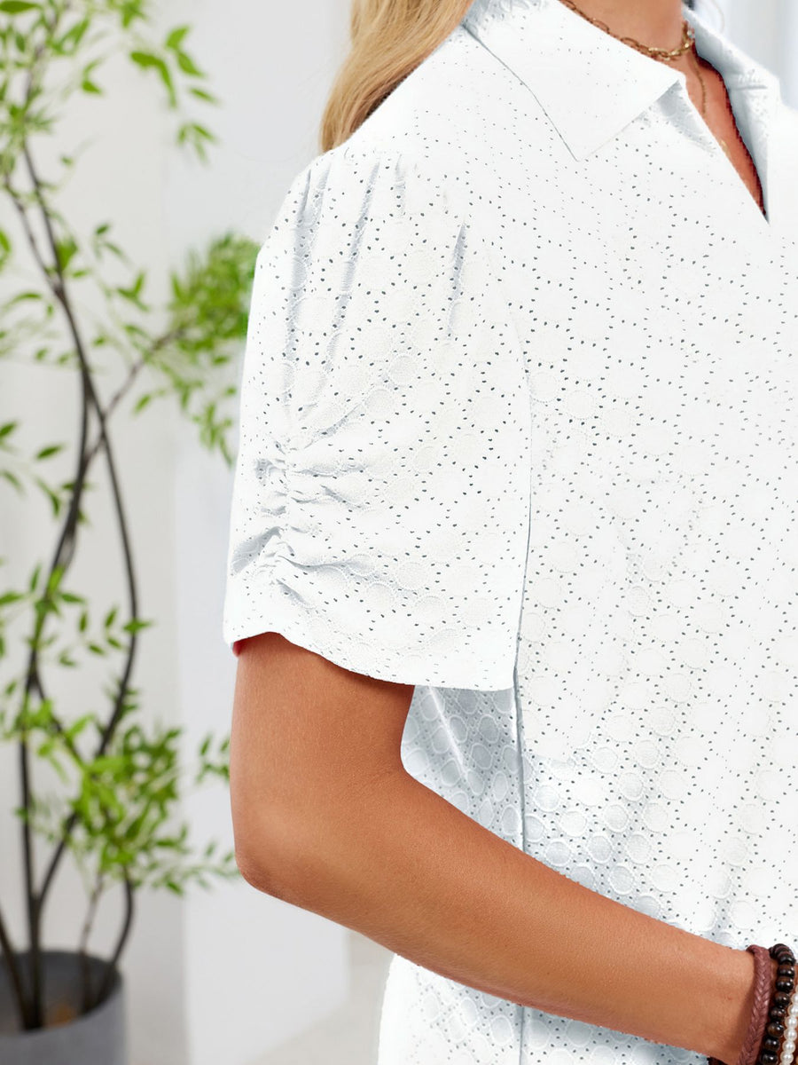 White eyelet ruched short sleeve blouse with a collared neckline.