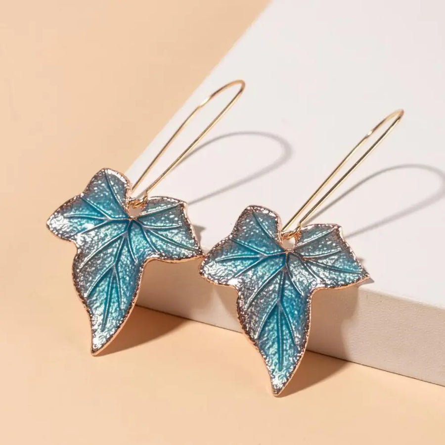 Sky blue enamel leaf drop earrings with gold-tone hooks.