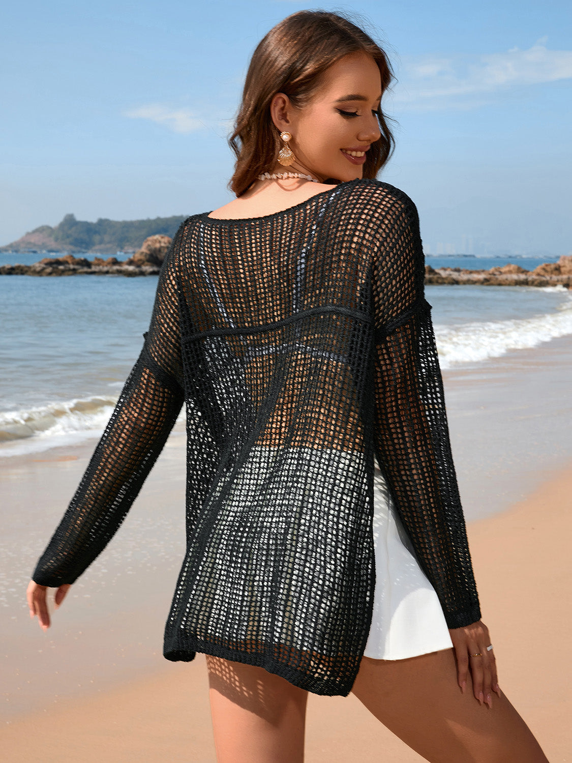 Black open-knit beach sweater with boat neck and long sleeves, acrylic.