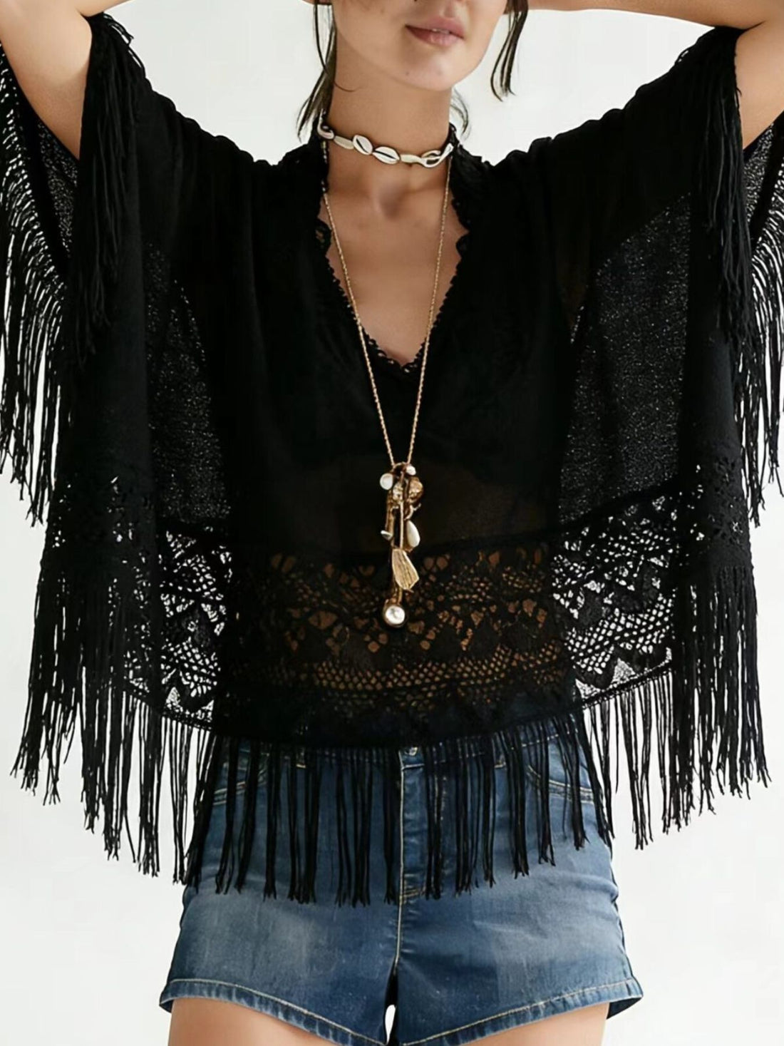 Black lace fringe cover-up with airy bohemian style and V-neckline.