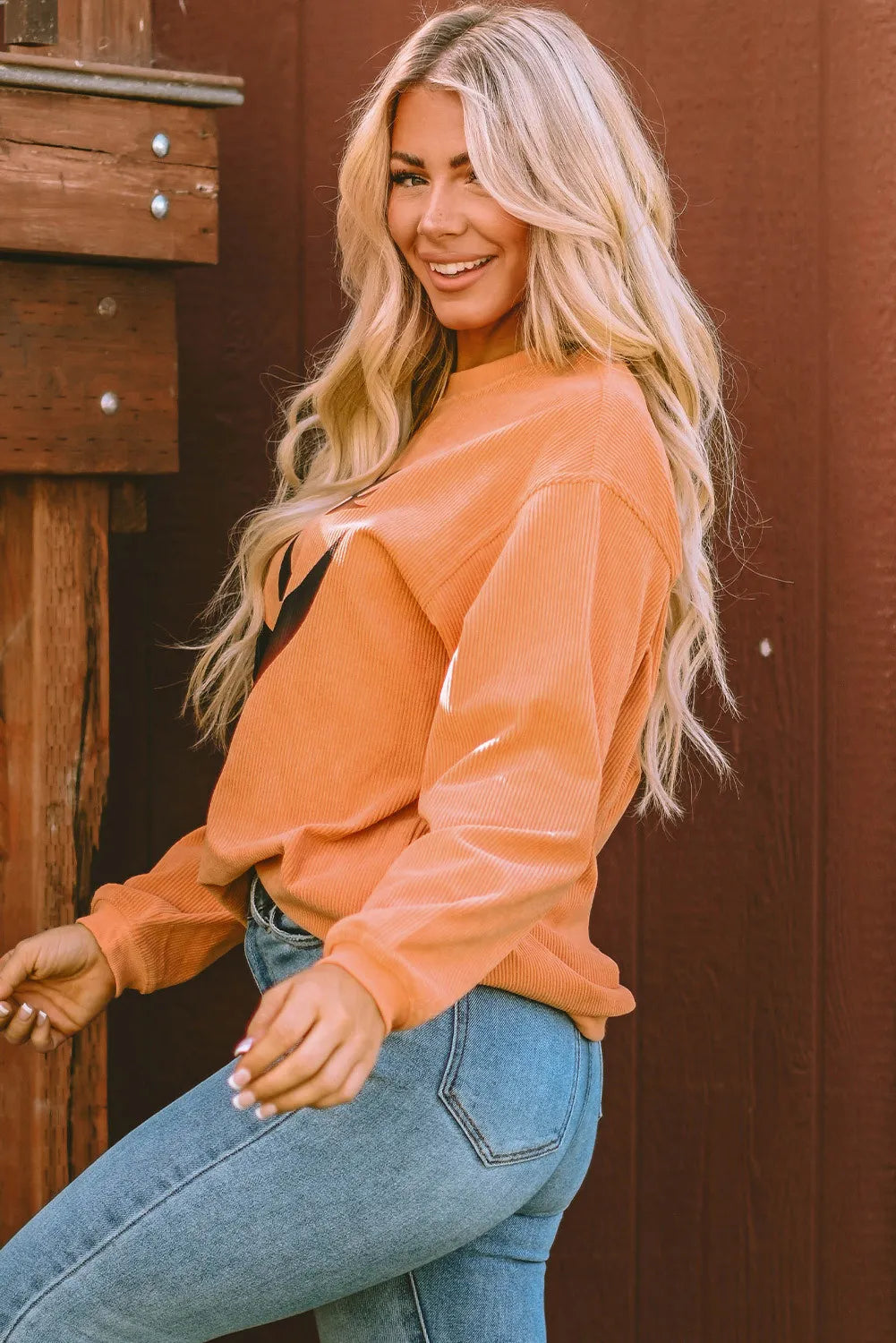 Caramel corduroy sweatshirt with jack-o'-lantern graphic detail.