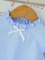 Light blue baby top with ruffled neckline and white bow detail