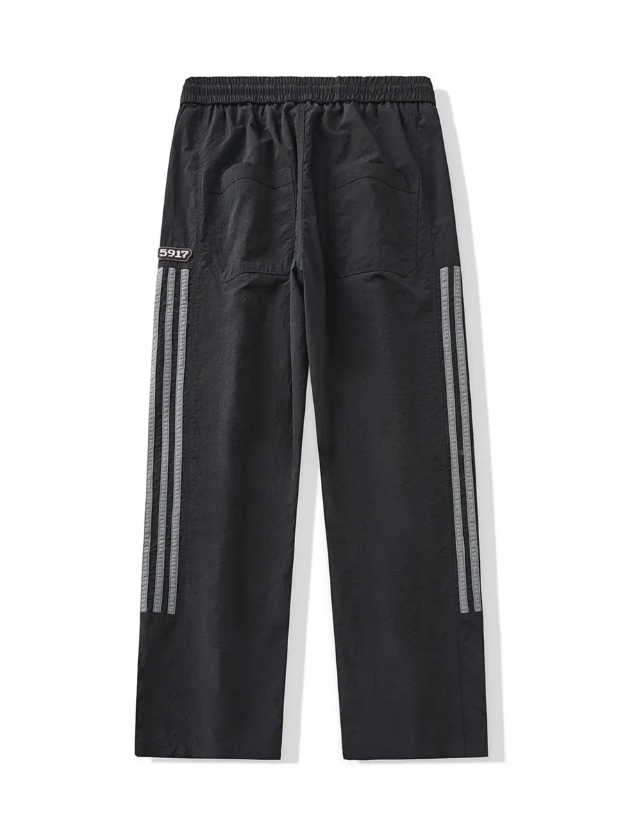 Black men's drawstring sweatpants with reflective side stripes and back pockets.