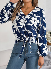 Navy floral knot-front blouse with ruffled cuffs and button detail