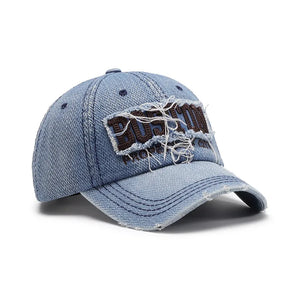 Distressed light wash denim baseball cap with embroidered Boston logo patch.