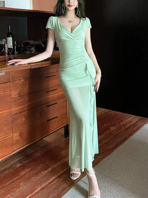 Light green surplice ruffle maxi dress with ruched detail and sheer skirt.