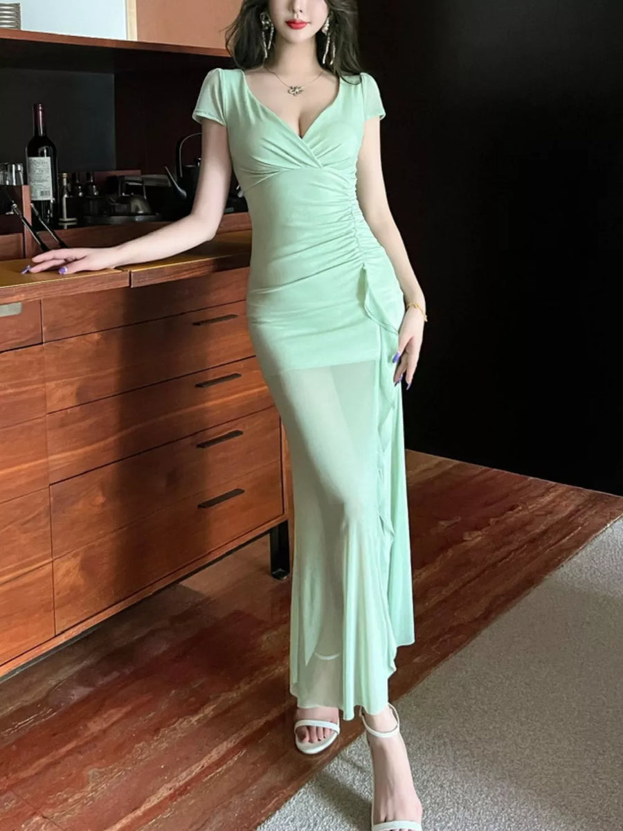 Light green surplice ruffle maxi dress with ruched detail and sheer skirt.