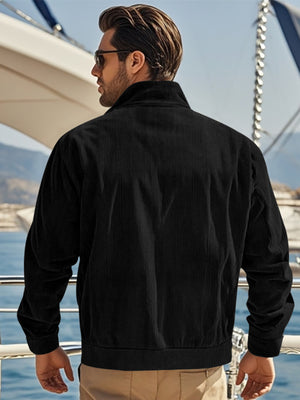Black corduroy bomber jacket with a stand-up collar and ribbed cuffs and hem.