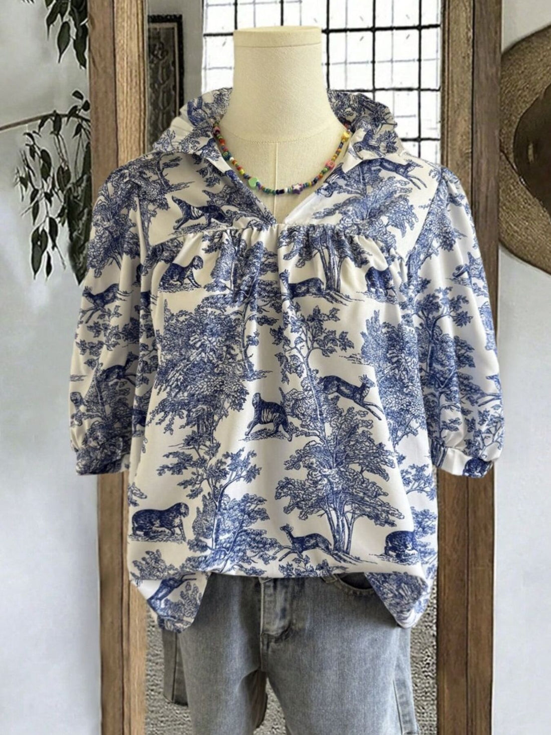 Toile de Jouy half sleeve blouse with a collared neckline and gathered details.