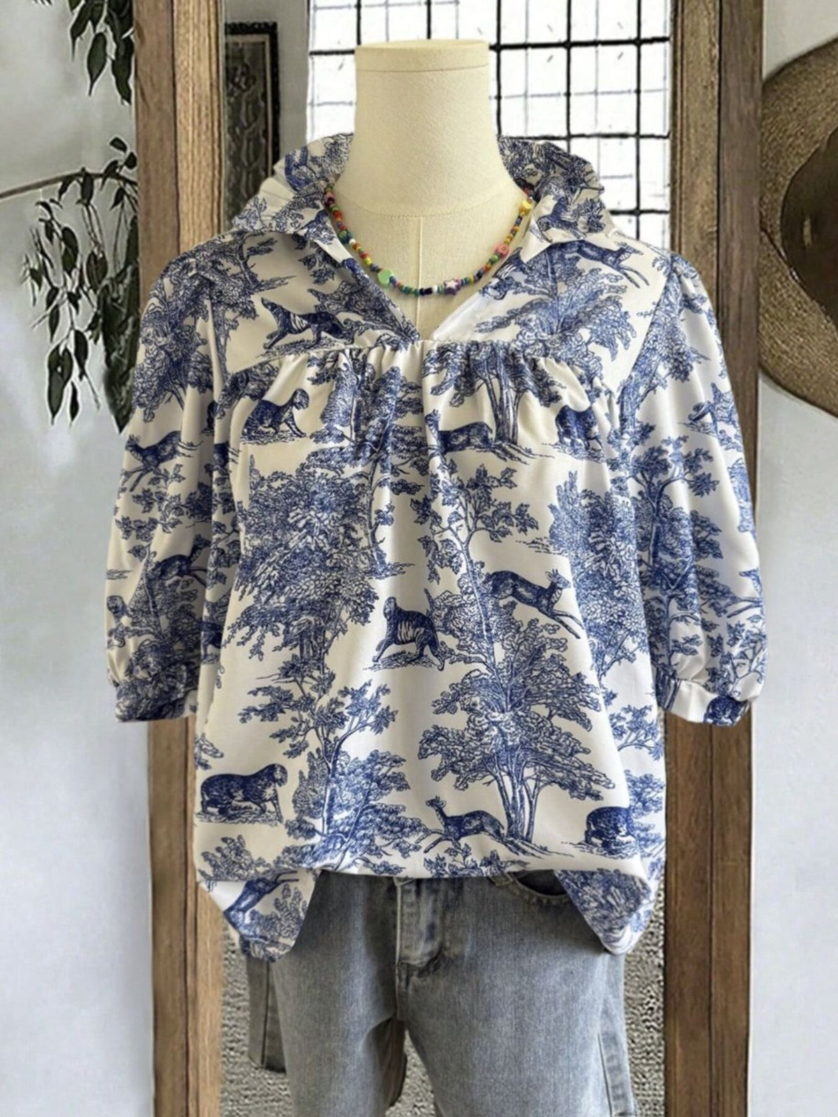 Toile de Jouy half sleeve blouse with a collared neckline and gathered details.