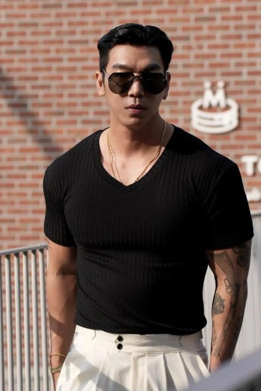Black ribbed slim-fit V-neck tee with short sleeves.