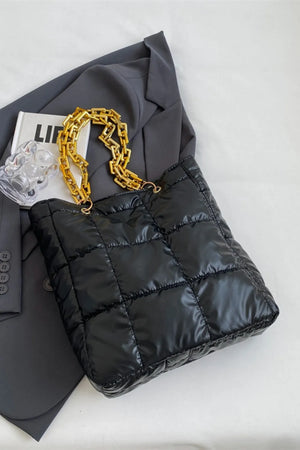 Black quilted nylon tote bag with gold chain handle