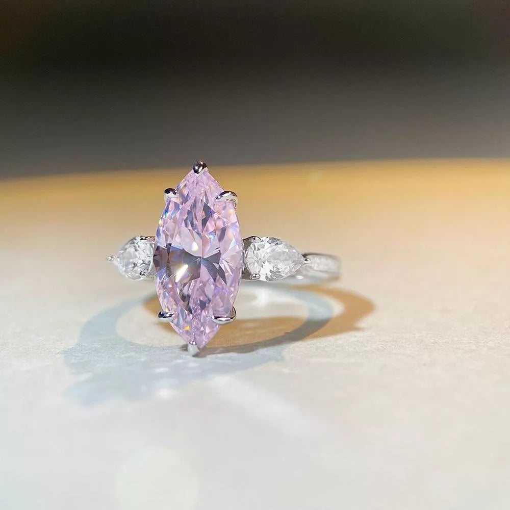 silver ring featuring marquise cut stone and geometric