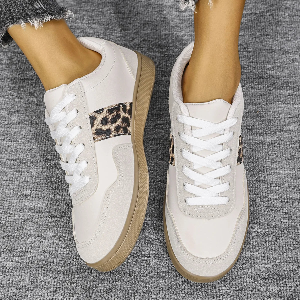White retro sneakers with leopard print panel detail and white laces.