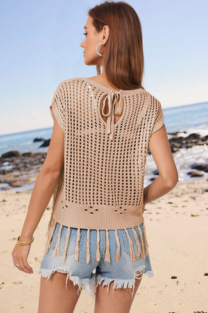 Tan open-knit cover-up with tie back and tassel hem detail.