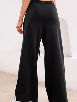 Black cotton maternity pants with drawstring and wide leg.