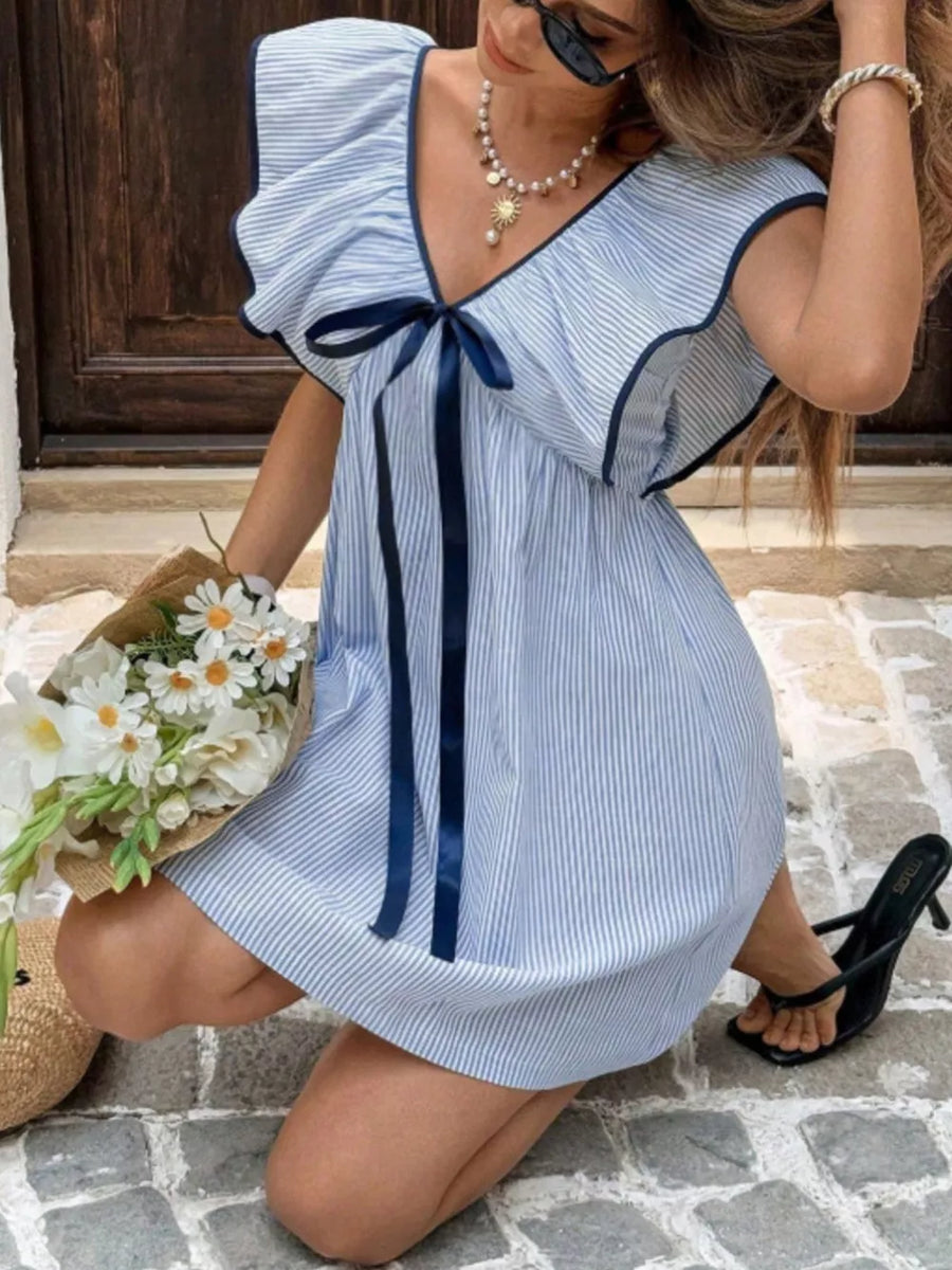 Blue striped mini dress with ruffled sleeves, V-neck, and bow detail.