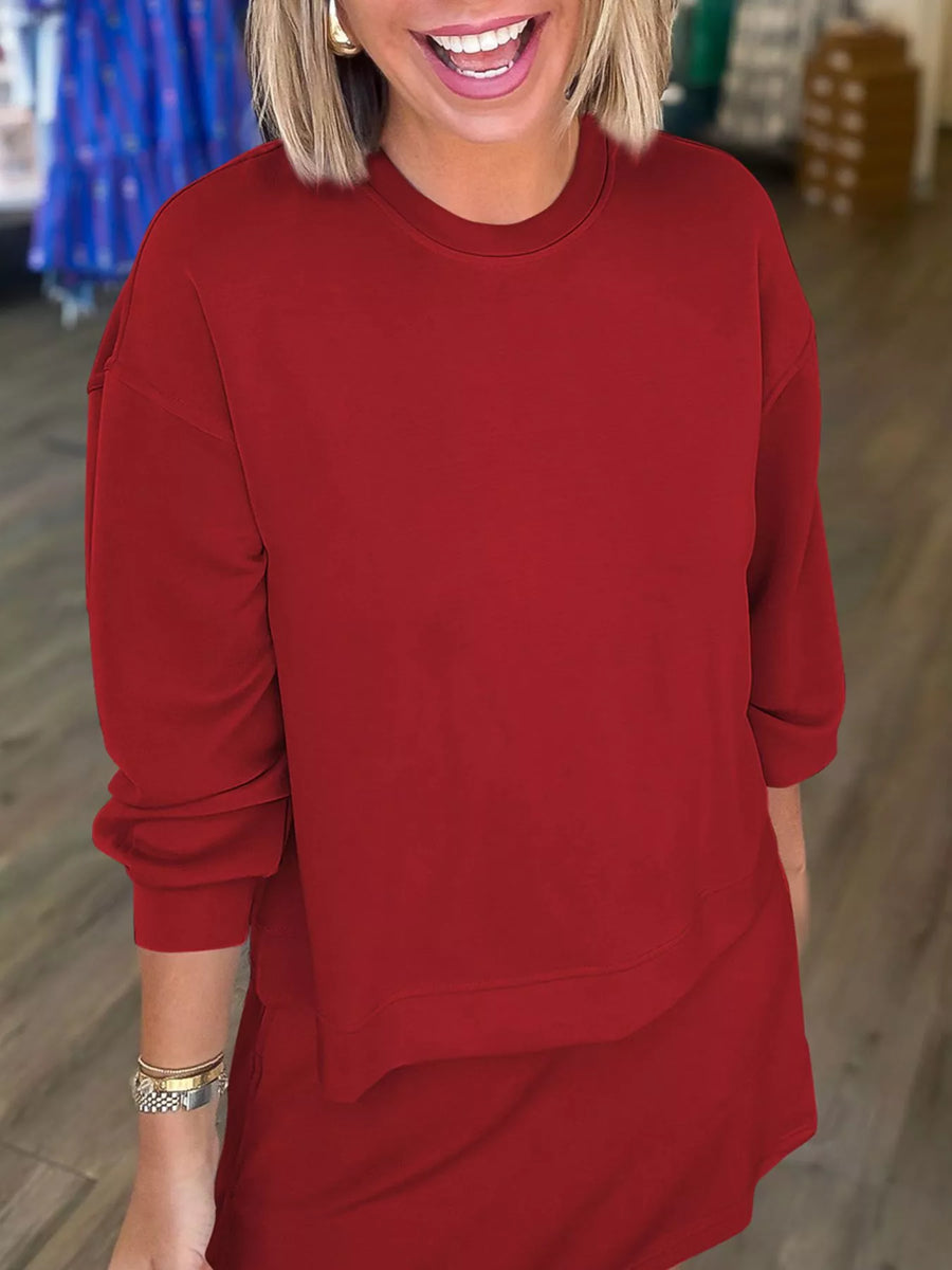 Deep red crewneck sweatshirt and matching skirt set with relaxed fit and cuffed sleeves.