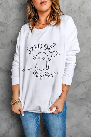 White crewneck sweatshirt with spooky ghost graphic and script text.