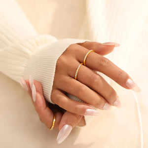 Gold pavé band stacking ring set with cubic zirconia accents.