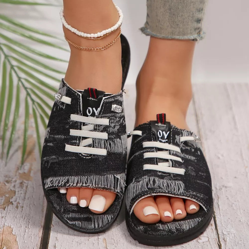 Black distressed canvas open-toe platform sandals with white laces and frayed trim.