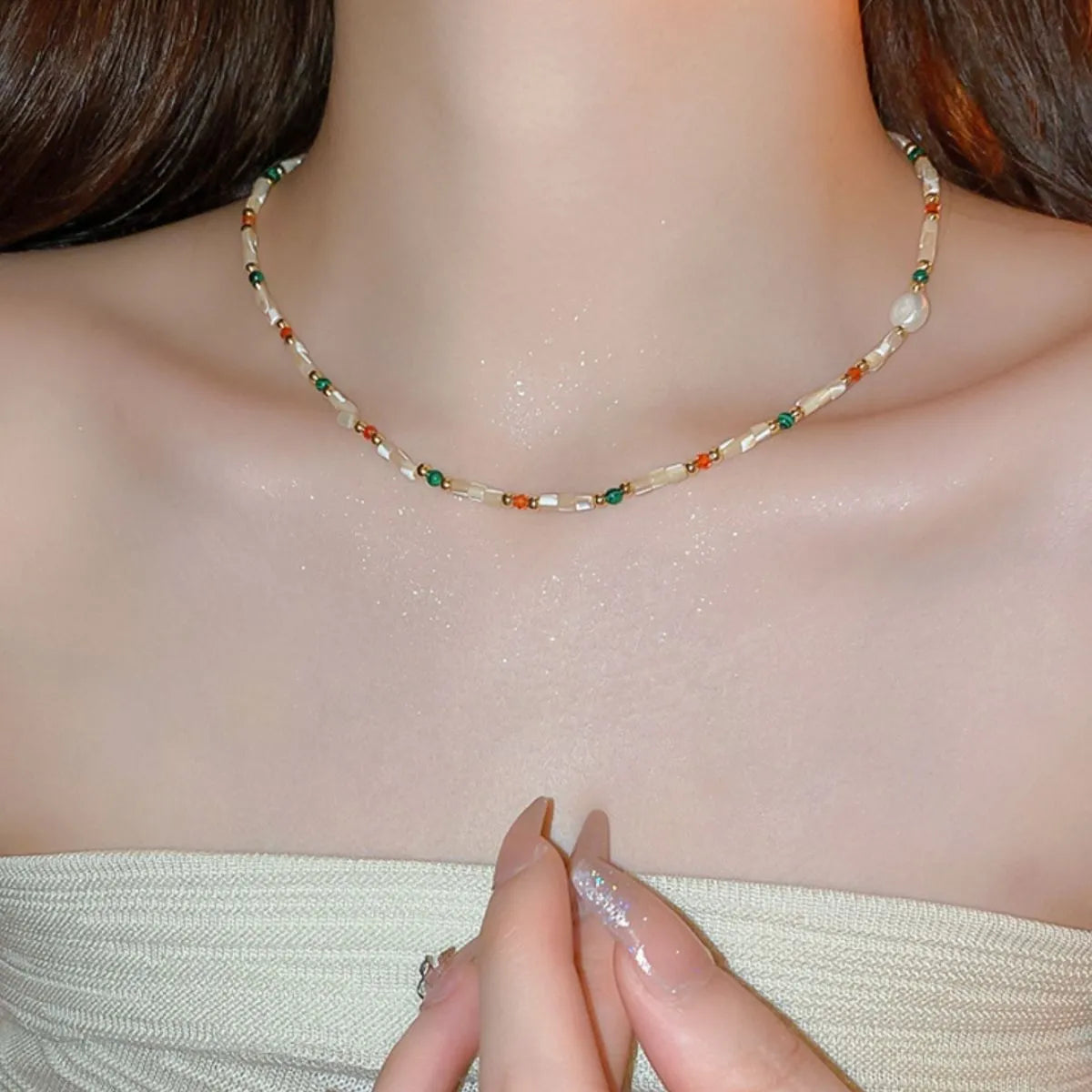 Multi-strand beaded collar necklace with gemstone accents and a pearl detail.